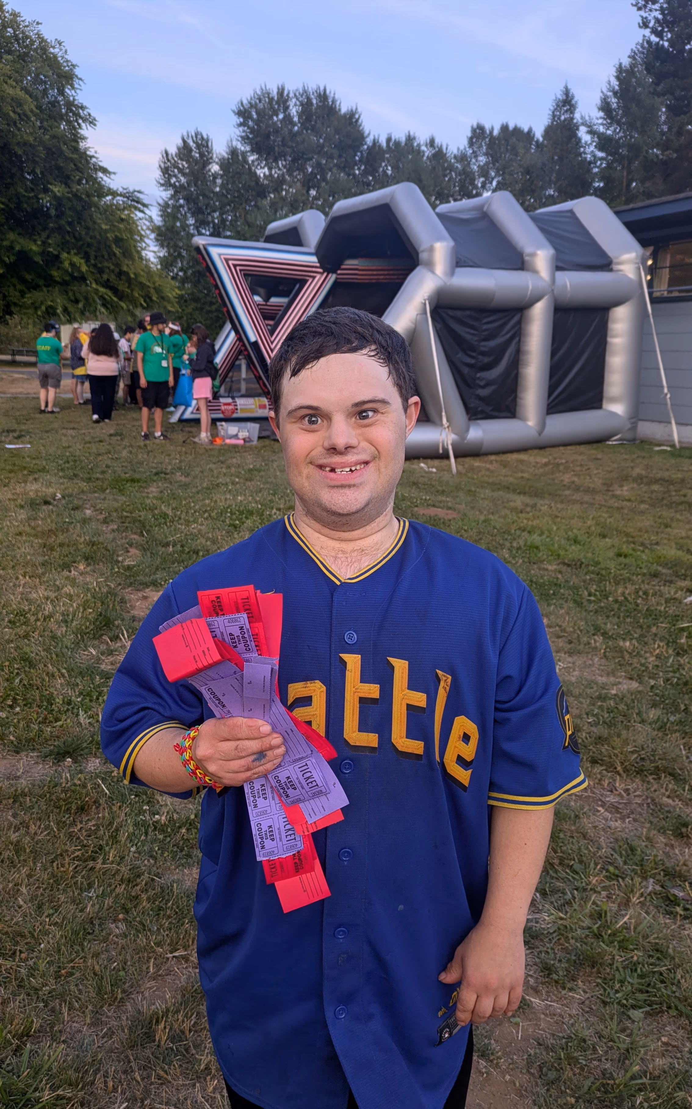 A camper at a carnival with lots of tickets